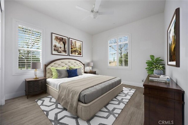 6207 Shelburne Dr, Bakersfield, CA 93306 - bedroom with multiple windows, wood finished floors, and baseboards