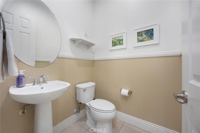 6207 Shelburne Dr, Bakersfield, CA 93306 - half bath with toilet, tile patterned floors, baseboards, and a sink