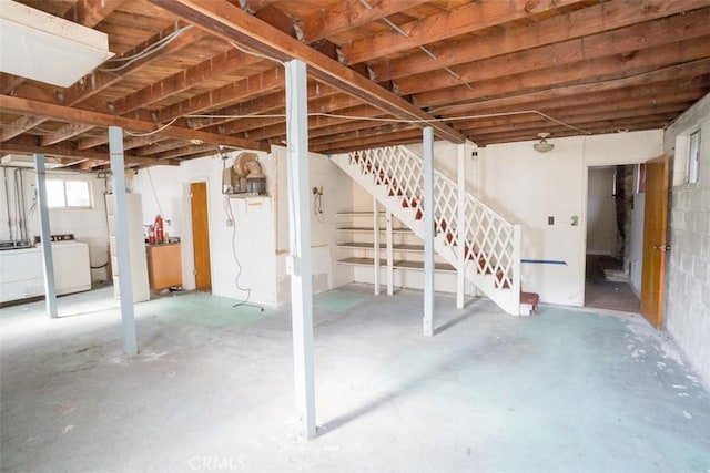basement with stairs and washer / dryer