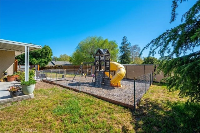 view of jungle gym featuring fence and a yard