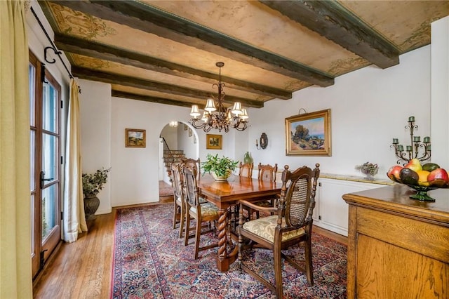 624 Calle Miramar, Redondo Beach, CA 90277 - dining area featuring arched walkways, beam ceiling, light wood-style floors, and a chandelier