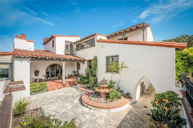 624 Calle Miramar, Redondo Beach, CA 90277 - rear view of house with stucco siding, a tiled roof, a chimney, and french doors