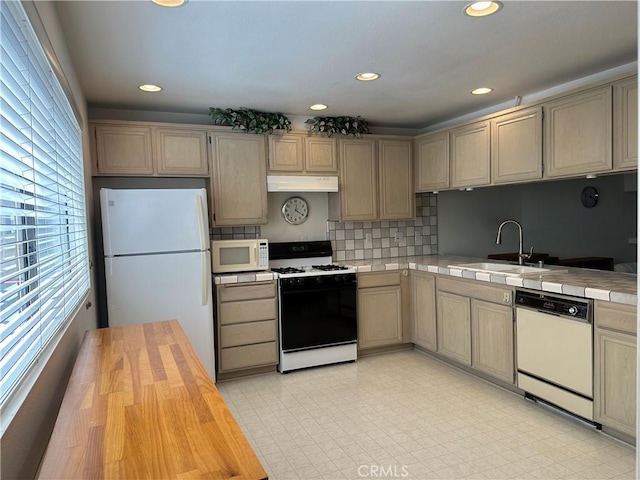 18405C Collins St Unit C, Tarzana, CA 91356 - kitchen with white appliances, under cabinet range hood, tile counters, decorative backsplash, and recessed lighting