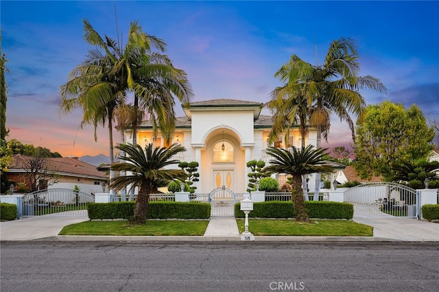 mediterranean / spanish-style house featuring a gate and driveway