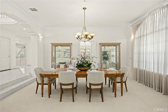 dining room with an inviting chandelier, a wealth of natural light, crown molding, and visible vents