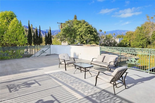 view of patio / terrace with a mountain view and an outdoor living space