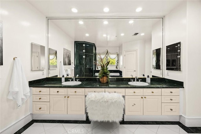 bathroom featuring a sink, baseboards, and visible vents