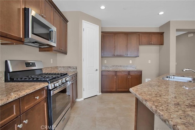 18870 Stetson St, Apple Valley, CA 92308 - kitchen featuring appliances with stainless steel finishes, light stone countertops, and recessed lighting