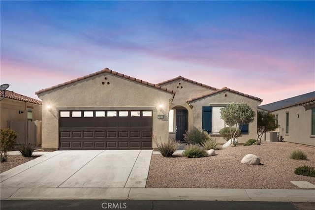 18870 Stetson St, Apple Valley, CA 92308 - mediterranean / spanish home featuring a garage, stucco siding, driveway, and a tiled roof