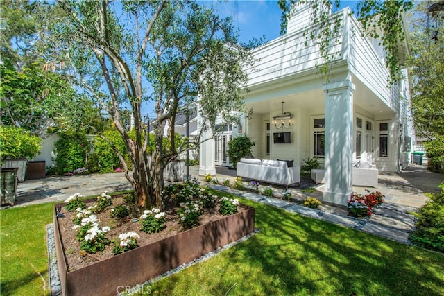 back of house with a lawn, a patio, and an outdoor living space