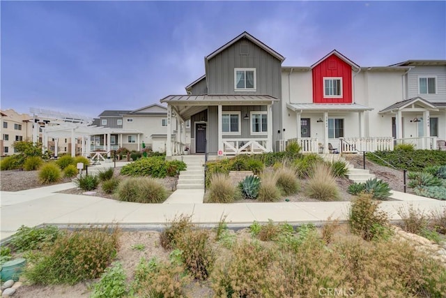 3860 Righetti Ranch Rd, San Luis Obispo, CA 93401 - view of front of house featuring covered porch, board and batten siding, a standing seam roof, a residential view, and metal roof