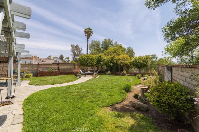 view of yard with a fenced backyard and a patio
