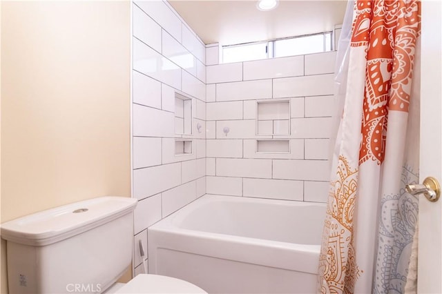 bathroom featuring shower / bath combo and toilet