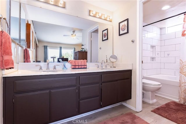 full bath featuring double vanity, a sink, ceiling fan, and toilet