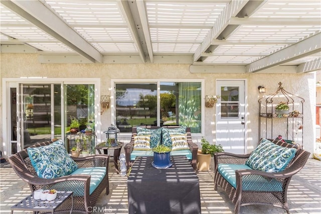sunroom / solarium featuring beamed ceiling and an outdoor hangout area