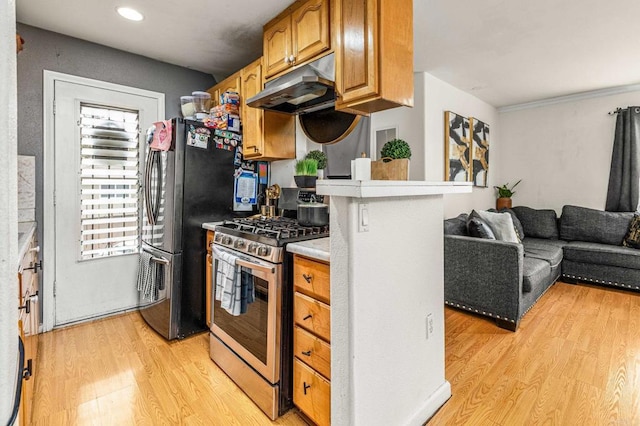 kitchen featuring recessed lighting, light wood finished floors, under cabinet range hood, stainless steel appliances, and light countertops
