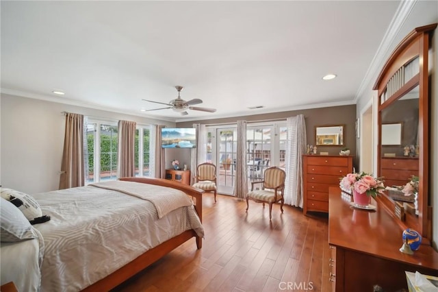 bedroom featuring recessed lighting, access to exterior, wood finished floors, and multiple windows