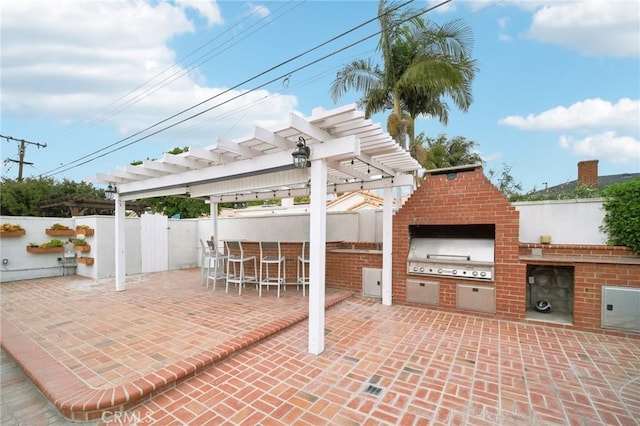 view of patio / terrace featuring fence, an outdoor bar, area for grilling, and a pergola