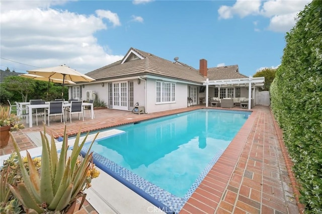view of swimming pool featuring outdoor lounge area, a pergola, french doors, and a fenced in pool