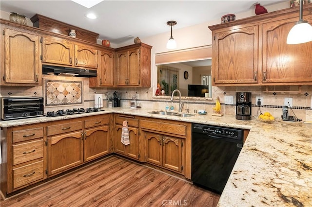 kitchen featuring a sink, black appliances, a toaster, backsplash, and under cabinet range hood
