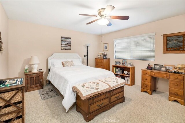 bedroom featuring a ceiling fan and light colored carpet