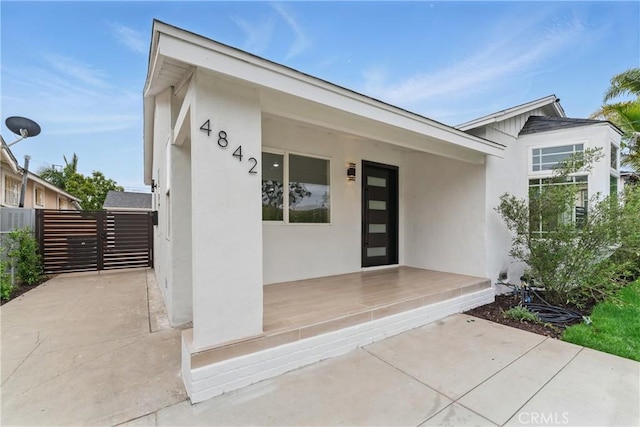 view of exterior entry with stucco siding