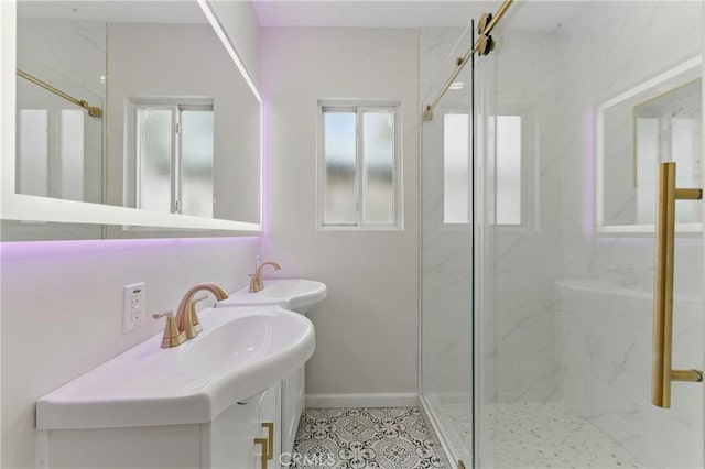 full bath featuring tile patterned flooring, vanity, and a marble finish shower