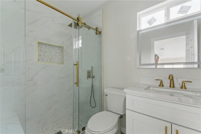 full bath with toilet, vanity, and a marble finish shower