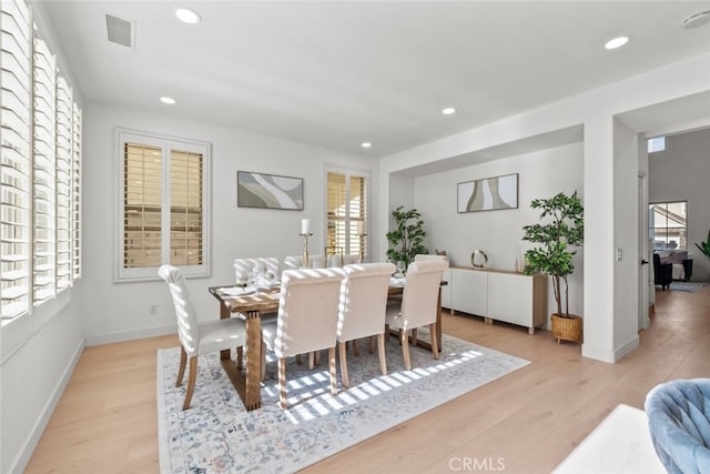 dining area featuring light wood finished floors, visible vents, and recessed lighting