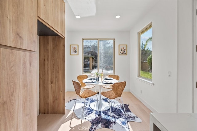 dining area featuring baseboards, a healthy amount of sunlight, light wood-style floors, and recessed lighting