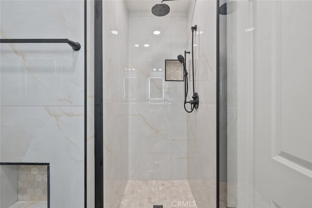 full bath with a marble finish shower