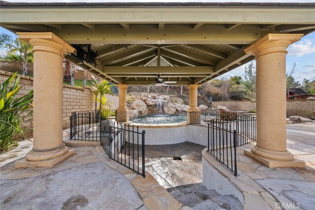 view of patio featuring a fenced backyard, a gazebo, and a ceiling fan