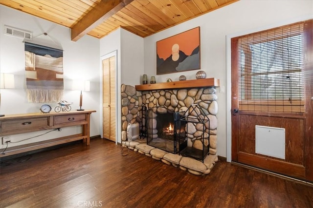 living area with wood ceiling, wood finished floors, a fireplace, and visible vents