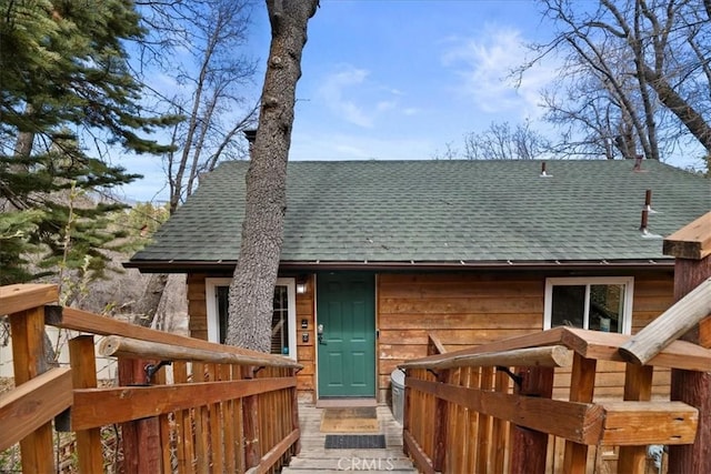 exterior space with a shingled roof