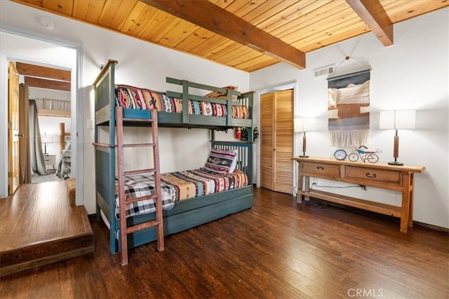 bedroom featuring wooden ceiling, visible vents, wood finished floors, and beamed ceiling