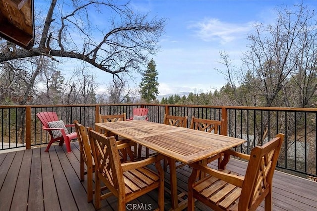 wooden terrace with outdoor dining space