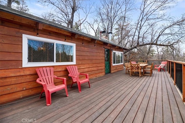 wooden terrace featuring outdoor dining space