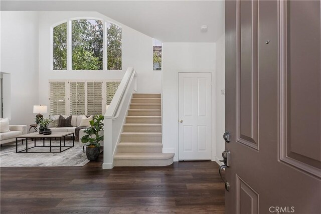 1 Giverny, Newport Coast, CA 92657 - entrance foyer with dark wood-style flooring, vaulted ceiling, and stairway