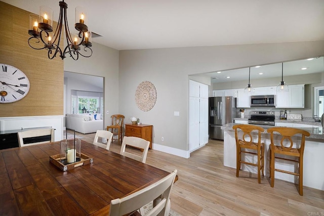 dining area with a notable chandelier, light wood-style floors, baseboards, lofted ceiling, and recessed lighting