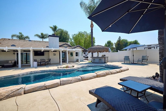 view of swimming pool featuring exterior kitchen, a fenced in pool, fence, an outdoor hangout area, and a patio