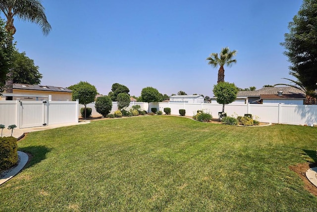 view of yard with a gate and a fenced backyard