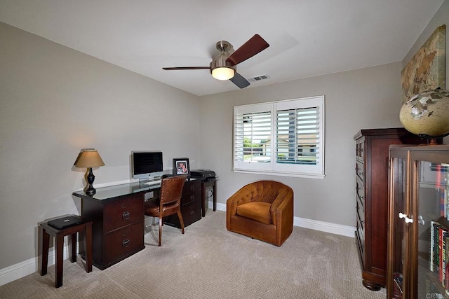 office space featuring visible vents, baseboards, light colored carpet, and ceiling fan