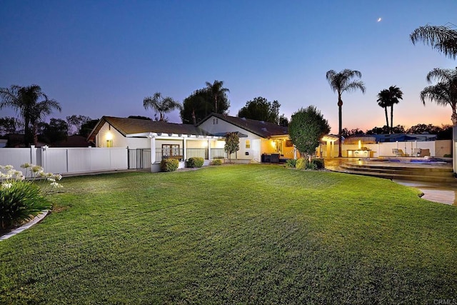 yard at dusk featuring central air condition unit and fence