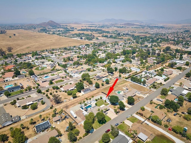 birds eye view of property with a mountain view