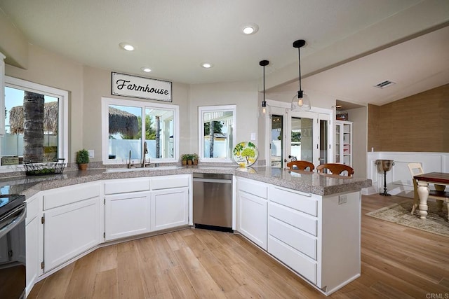 kitchen featuring black / electric stove, dishwasher, visible vents, a peninsula, and white cabinetry