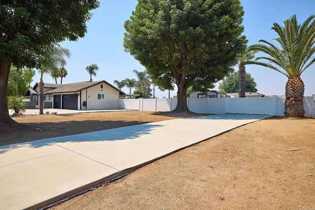 exterior space featuring fence and an attached garage