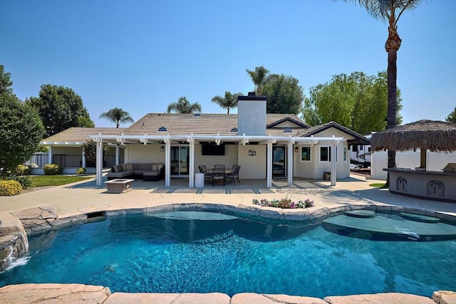 pool with fence, an outdoor living space with a fire pit, and a patio