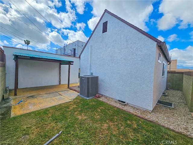 view of property exterior featuring a fenced backyard, stucco siding, a patio area, cooling unit, and a lawn