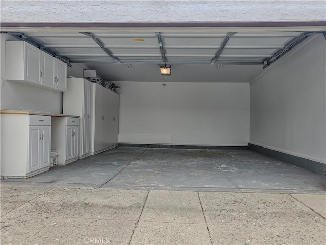 1954 W 71st, Los Angeles, CA 90047 - garage featuring a garage door opener and baseboards