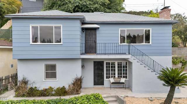 3800 Toland Way, Los Angeles, CA 90065 - view of front of property with a chimney, stucco siding, fence, a patio area, and stairs